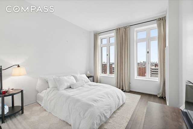 543 W 122nd St Unit 17C, New York City, NY 10027 - bedroom with wood finished floors and lofted ceiling