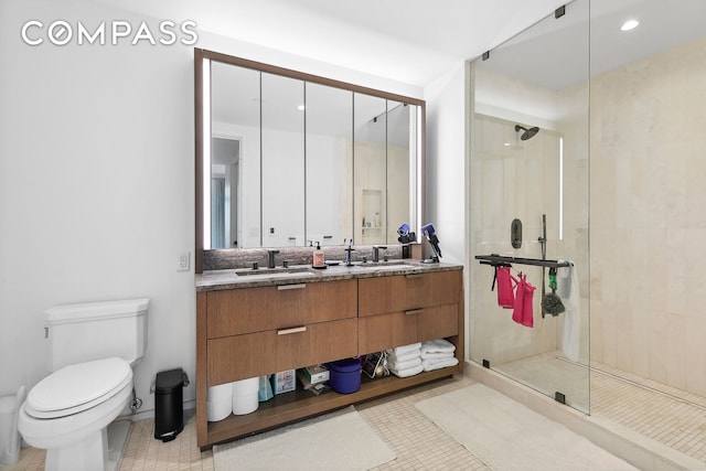 full bath featuring a stall shower, toilet, double vanity, and tile patterned floors