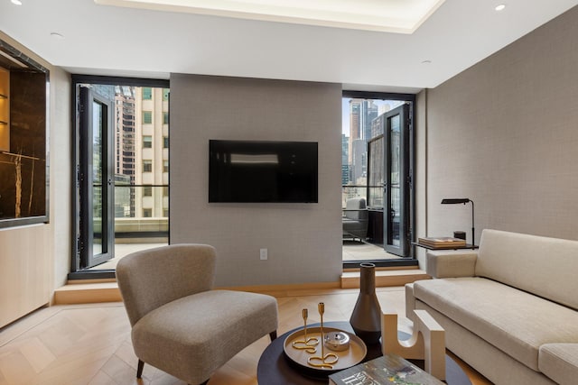 685 5th Ave Unit 15B, New York City, NY 10022 - living room with plenty of natural light, floor to ceiling windows, recessed lighting, and an accent wall
