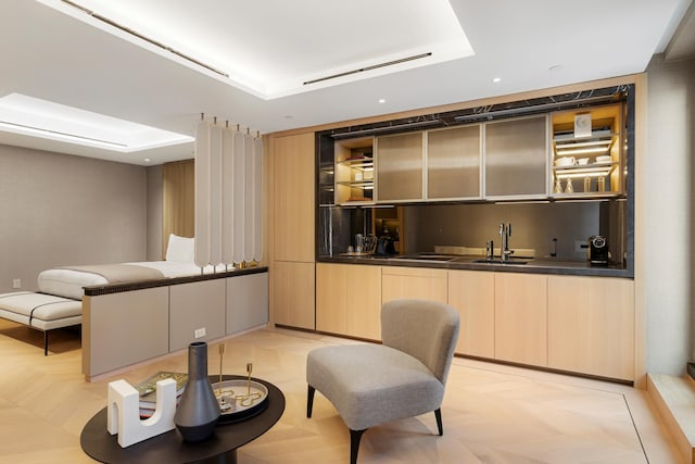 685 5th Ave Unit 15B, New York City, NY 10022 - living area featuring bar with sink, a tray ceiling, and recessed lighting