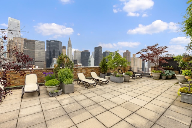 view of patio featuring a skyline view and fence