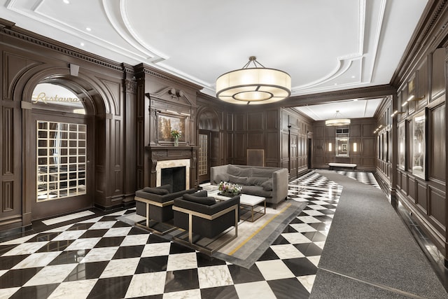 lobby featuring a decorative wall, ornamental molding, and recessed lighting