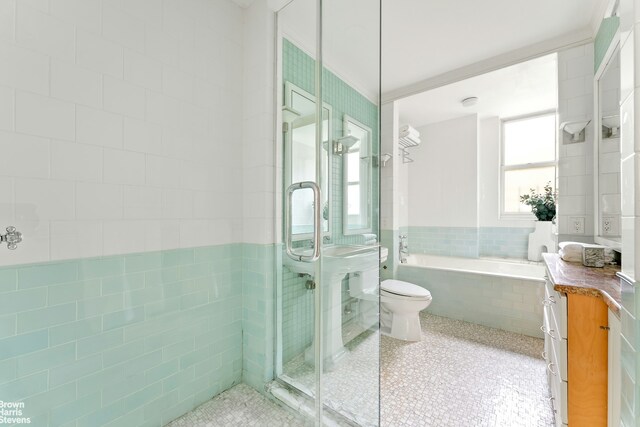 607 W End Ave Unit 4A, New York City, NY 10024 - bathroom featuring a bath, tile walls, toilet, vanity, and a shower