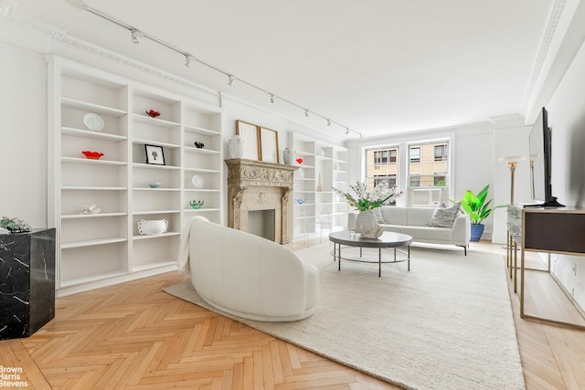 607 W End Ave Unit 4A, New York City, NY 10024 - living room featuring rail lighting, a premium fireplace, built in features, and crown molding
