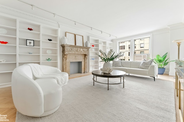 607 W End Ave Unit 4A, New York City, NY 10024 - living area featuring track lighting, built in shelves, and a high end fireplace
