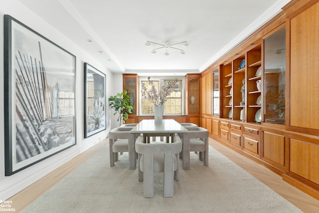 607 W End Ave Unit 4A, New York City, NY 10024 - dining space with healthy amount of natural light, a chandelier, light wood-type flooring, and ornamental molding