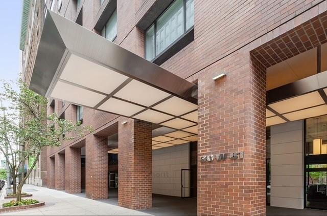 view of exterior entry featuring brick siding