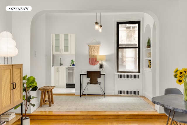 225 W 25th St Unit 3C, New York City, NY 10001 - entryway featuring radiator, light wood-style flooring, and arched walkways