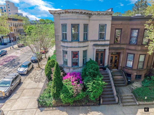 view of front of property featuring french doors and stairs