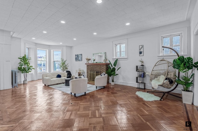 living area featuring healthy amount of natural light, baseboards, a fireplace, and recessed lighting