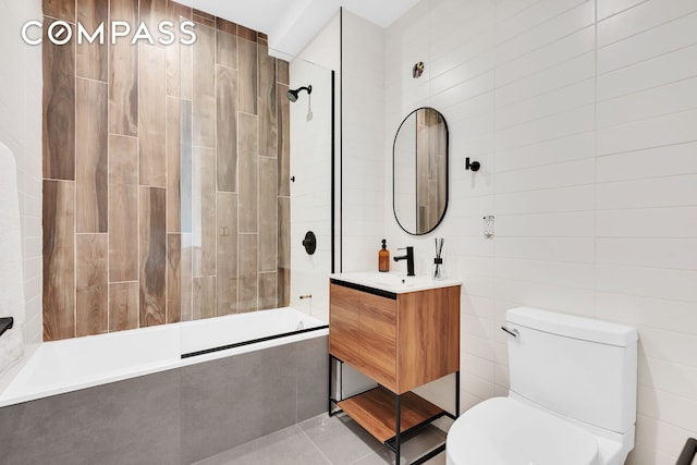 156 Somers St Unit 3B, New York City, NY 11233 - bathroom with tiled shower / bath combo, toilet, vanity, tile patterned floors, and tile walls