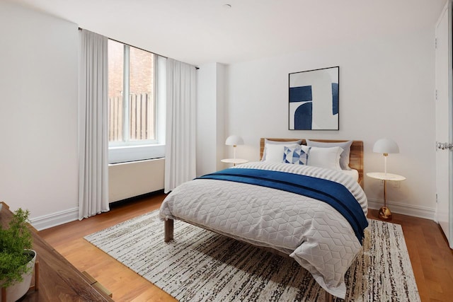 bedroom with wood finished floors and baseboards