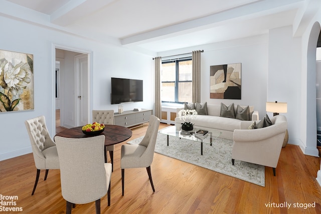 235 W End Ave Unit 3C, New York City, NY 10023 - living area featuring beamed ceiling, arched walkways, light wood-style flooring, and baseboards