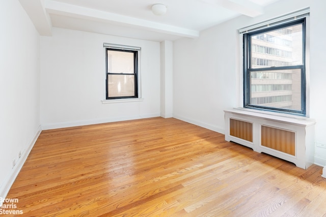 235 W End Ave Unit 3C, New York City, NY 10023 - empty room featuring beamed ceiling, light wood finished floors, radiator heating unit, and baseboards