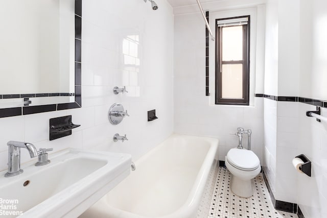 235 W End Ave Unit 3C, New York City, NY 10023 - bathroom with tile walls, a sink, toilet, and bathing tub / shower combination