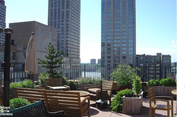 235 W End Ave Unit 3C, New York City, NY 10023 - view of patio with a city view and an outdoor hangout area