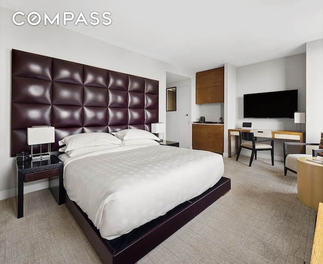 carpeted bedroom featuring baseboards