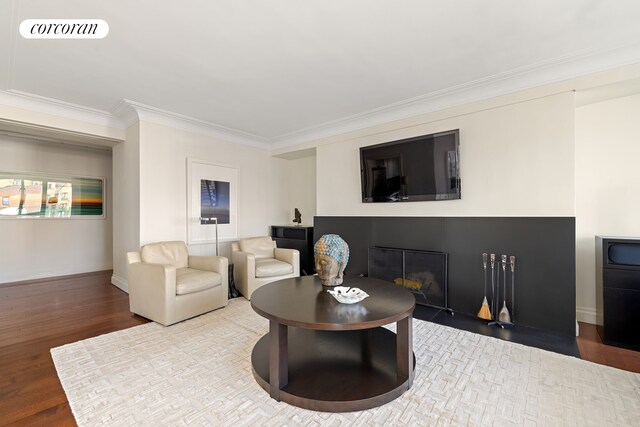 200 E 66th St Unit B1702, New York City, NY 10065 - living area featuring crown molding, baseboards, wood finished floors, and a glass covered fireplace