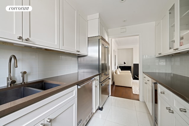 200 E 66th St Unit B1702, New York City, NY 10065 - kitchen with a sink, dark countertops, white cabinetry, dishwasher, and recessed lighting