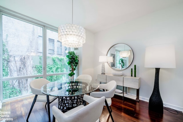 dining room featuring hardwood / wood-style floors, a chandelier, and baseboards