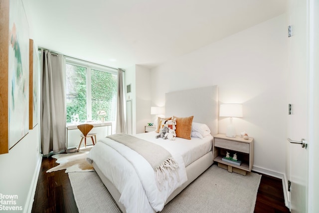 bedroom with wood finished floors and baseboards