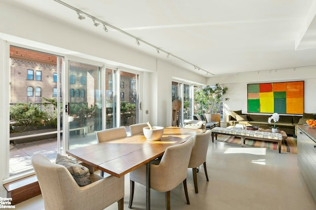 101 W 79th St Unit 14E, New York City, NY 10024 - dining room featuring rail lighting and concrete floors