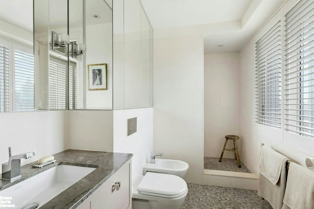 101 W 79th St Unit 14E, New York City, NY 10024 - bathroom with a bidet, toilet, vanity, a walk in shower, and tile walls
