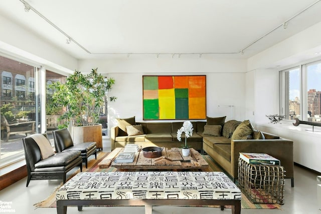 101 W 79th St Unit 14E, New York City, NY 10024 - living area featuring rail lighting and finished concrete floors