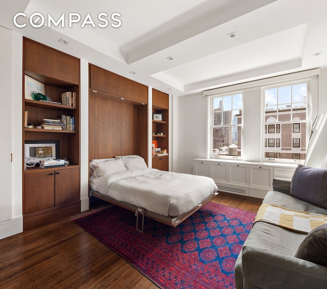575 Park Ave Unit 1201, New York City, NY 10065 - bedroom featuring a raised ceiling and dark wood finished floors