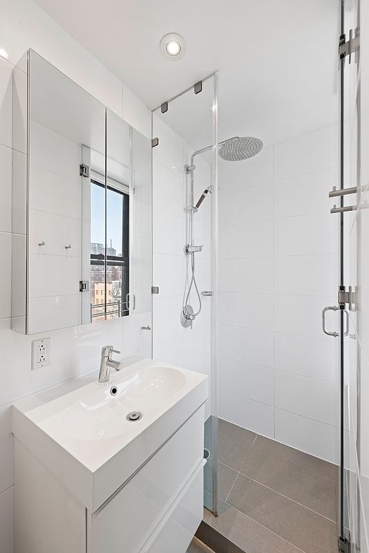 64 Macdougal St Unit 15, New York City, NY 10012 - bathroom featuring a stall shower, vanity, and recessed lighting