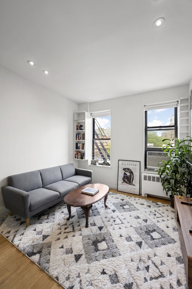 64 Macdougal St Unit 15, New York City, NY 10012 - living area featuring radiator heating unit, wood finished floors, and recessed lighting