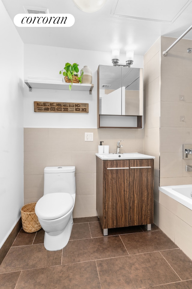 186 Putnam Ave Unit 2B, New York City, NY 11216 - full bathroom featuring vanity, tiled shower / bath, tile walls, and tile patterned floors