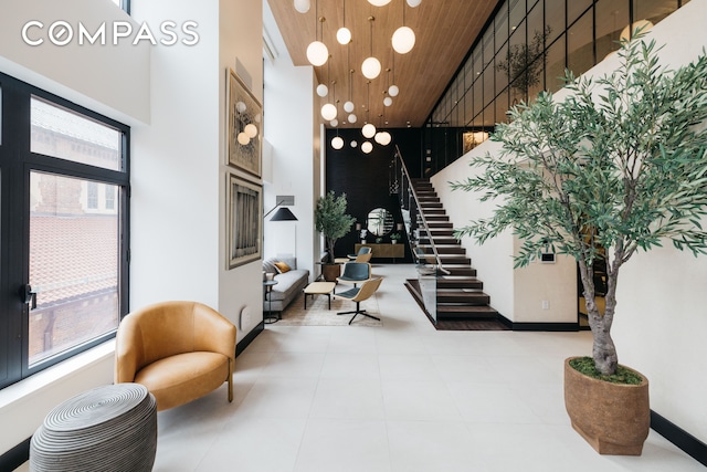 400 E 67th St Unit 7G, New York City, NY 10065 - lobby with stairway, a high ceiling, and wooden ceiling