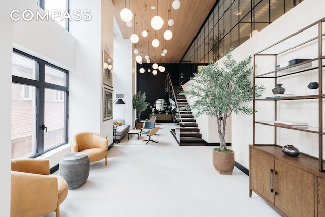 400 E 67th St Unit 7G, New York City, NY 10065 - community lobby featuring wood ceiling, stairway, and a high ceiling