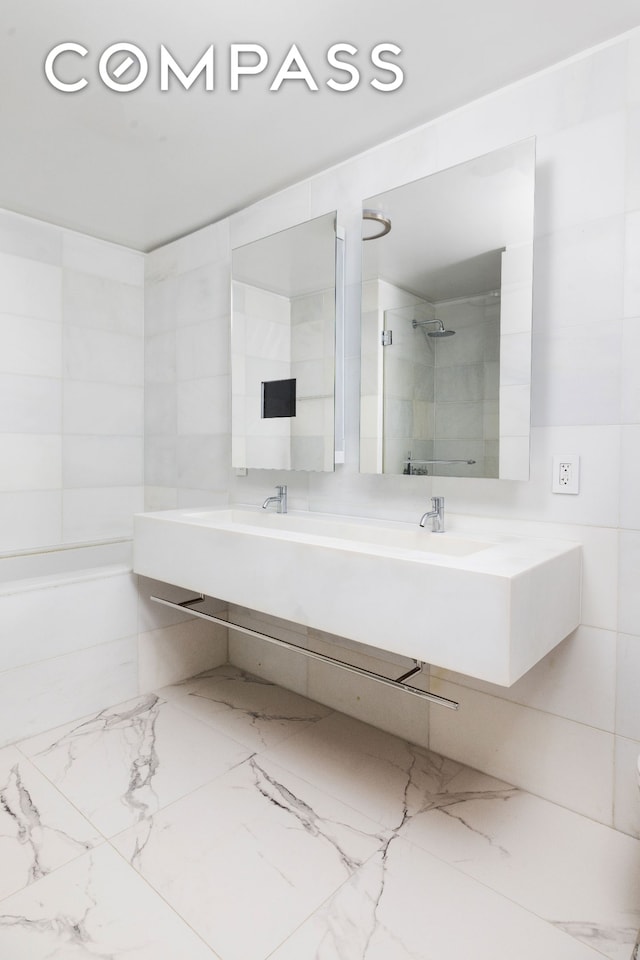 400 E 67th St Unit 7G, New York City, NY 10065 - full bathroom featuring marble finish flooring, double vanity, and a shower