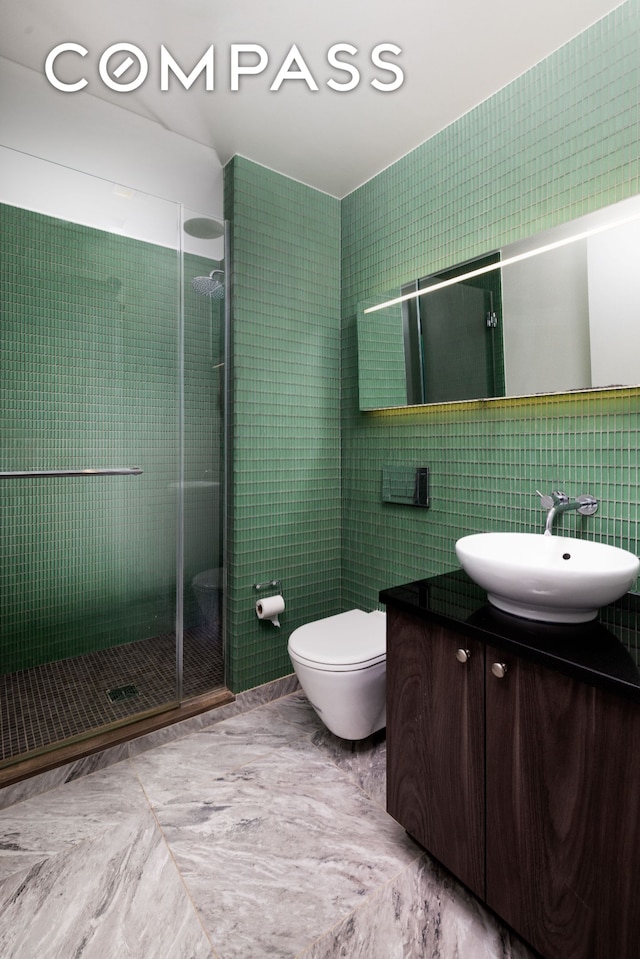 400 E 67th St Unit 7G, New York City, NY 10065 - full bath featuring tile walls, vanity, a shower stall, and toilet