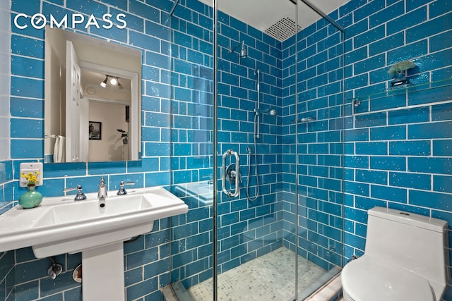 510 E 84th St Unit 1B, New York City, NY 10028 - bathroom with a shower stall, toilet, and tile walls