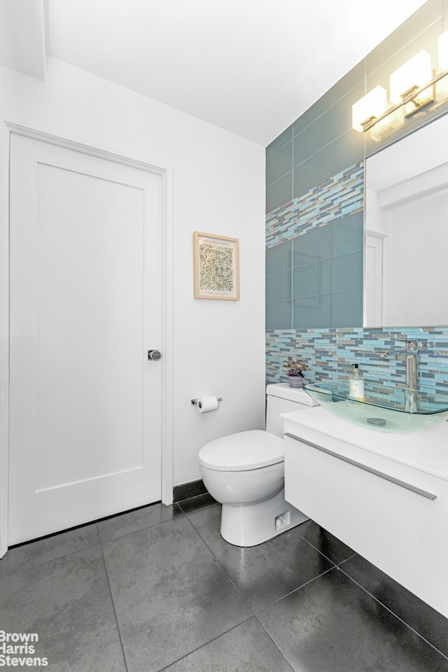 501 E 79th St Unit 5A, New York City, NY 10075 - bathroom with vanity, decorative backsplash, and toilet