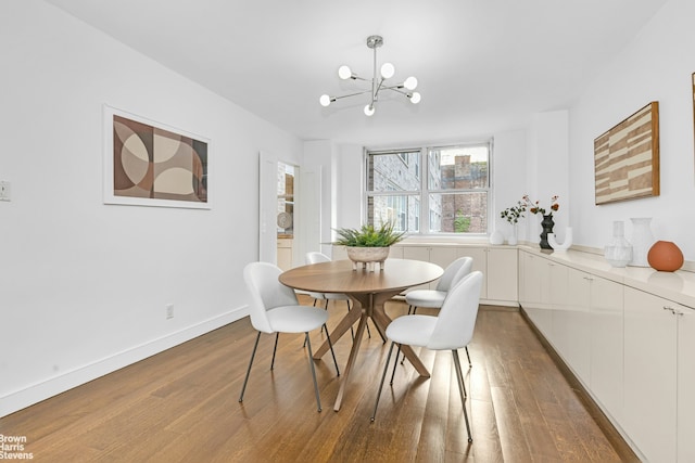 501 E 79th St Unit 5A, New York City, NY 10075 - dining room featuring wood finished floors and a chandelier