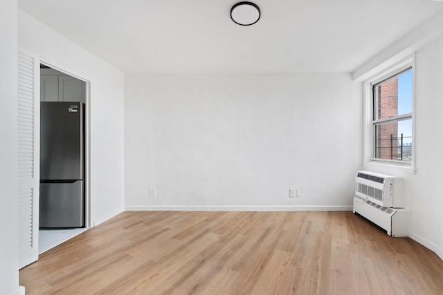 1655 Flatbush Ave Unit B1912, New York City, NY 11210 - empty room with light wood finished floors, baseboards, and an AC wall unit