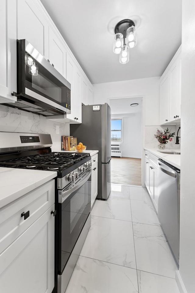 1655 Flatbush Ave Unit B1912, New York City, NY 11210 - kitchen featuring appliances with stainless steel finishes, white cabinets, a sink, and light marble finish flooring