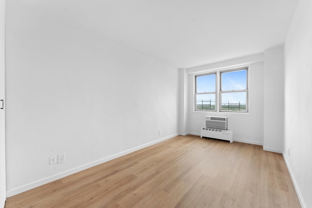 1655 Flatbush Ave Unit B1912, New York City, NY 11210 - unfurnished room featuring light wood-style flooring, baseboards, a baseboard heating unit, and an AC wall unit