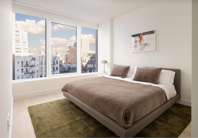 200 E 20th St Unit 5D, New York City, NY 10003 - bedroom with wood finished floors and a city view