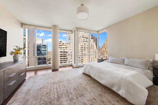 151 E 85th St Unit 17J, New York City, NY 10028 - bedroom featuring a view of skyline and wood finished floors