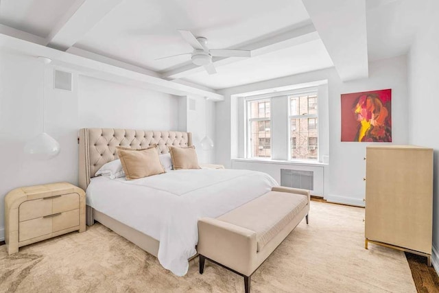 bedroom featuring radiator, ceiling fan, and beamed ceiling