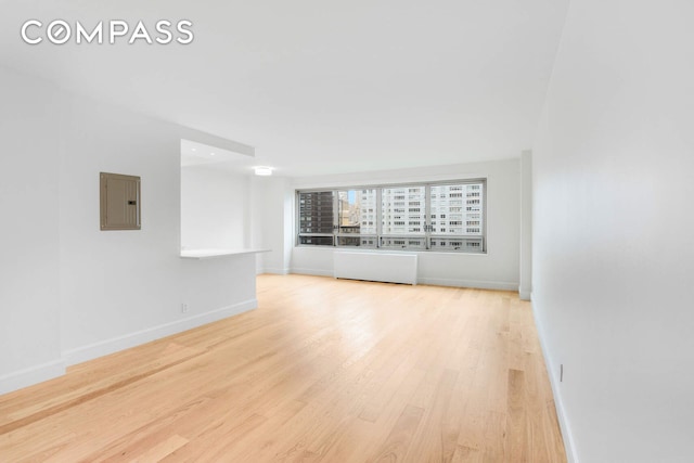 170 W End Ave Unit 12B, New York City, NY 10023 - spare room featuring electric panel, wood finished floors, and baseboards