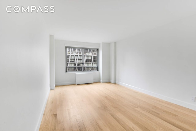 170 W End Ave Unit 12B, New York City, NY 10023 - unfurnished room featuring light wood-style floors, baseboards, and radiator