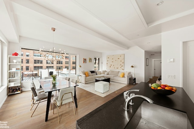 345 W 14th St Unit 8D, New York City, NY 10014 - dining area with light wood-type flooring and a chandelier