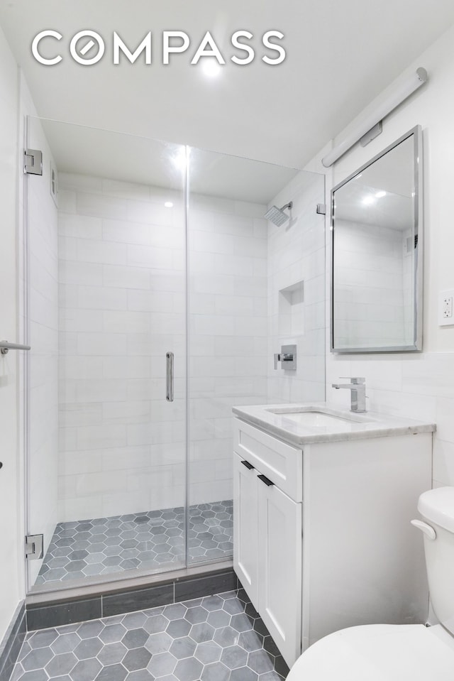 205 W End Ave Unit 15H, New York City, NY 10023 - full bathroom with toilet, vanity, tile patterned floors, and a stall shower