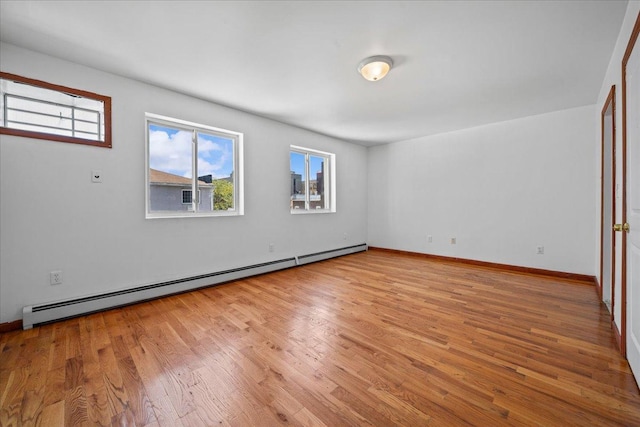 53 Woods Place, New York City, NY 11226 - unfurnished room with a baseboard heating unit, plenty of natural light, and light wood-type flooring